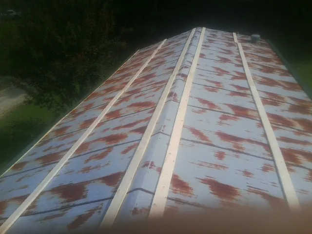 Rusted metal roof panels with new wood purlins before replacement — Storm Damage Roof Repair in Duncan by Roofing Brothers